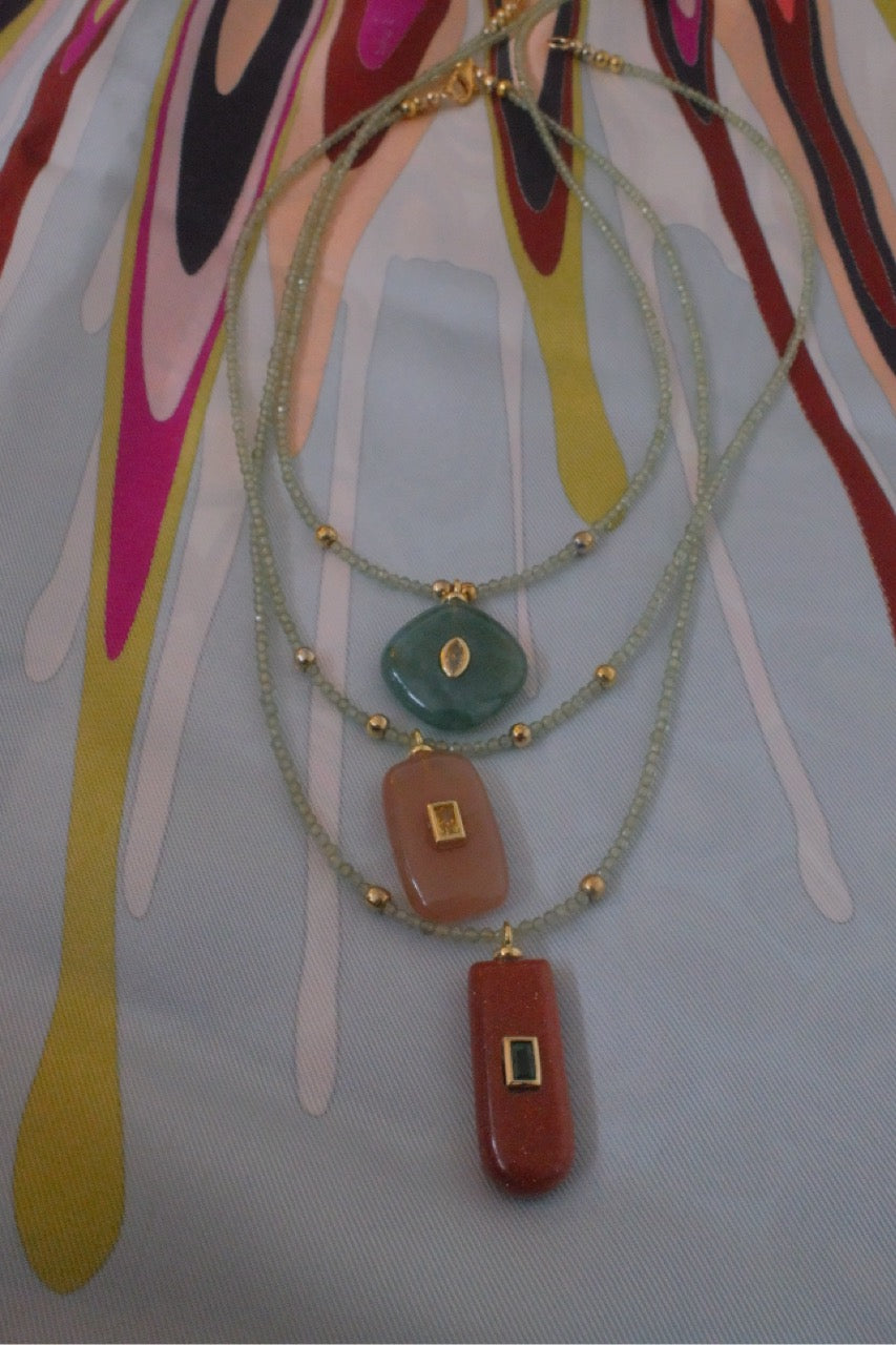 Green quartz gemstone with earthy charm pendant