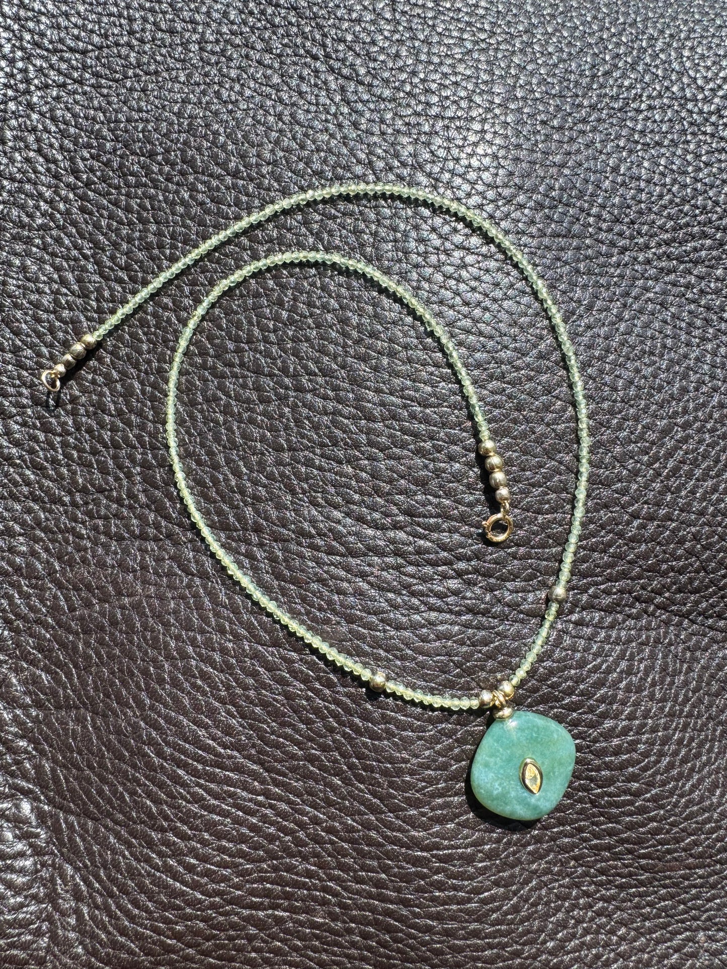 Green quartz gemstone with earthy charm pendant
