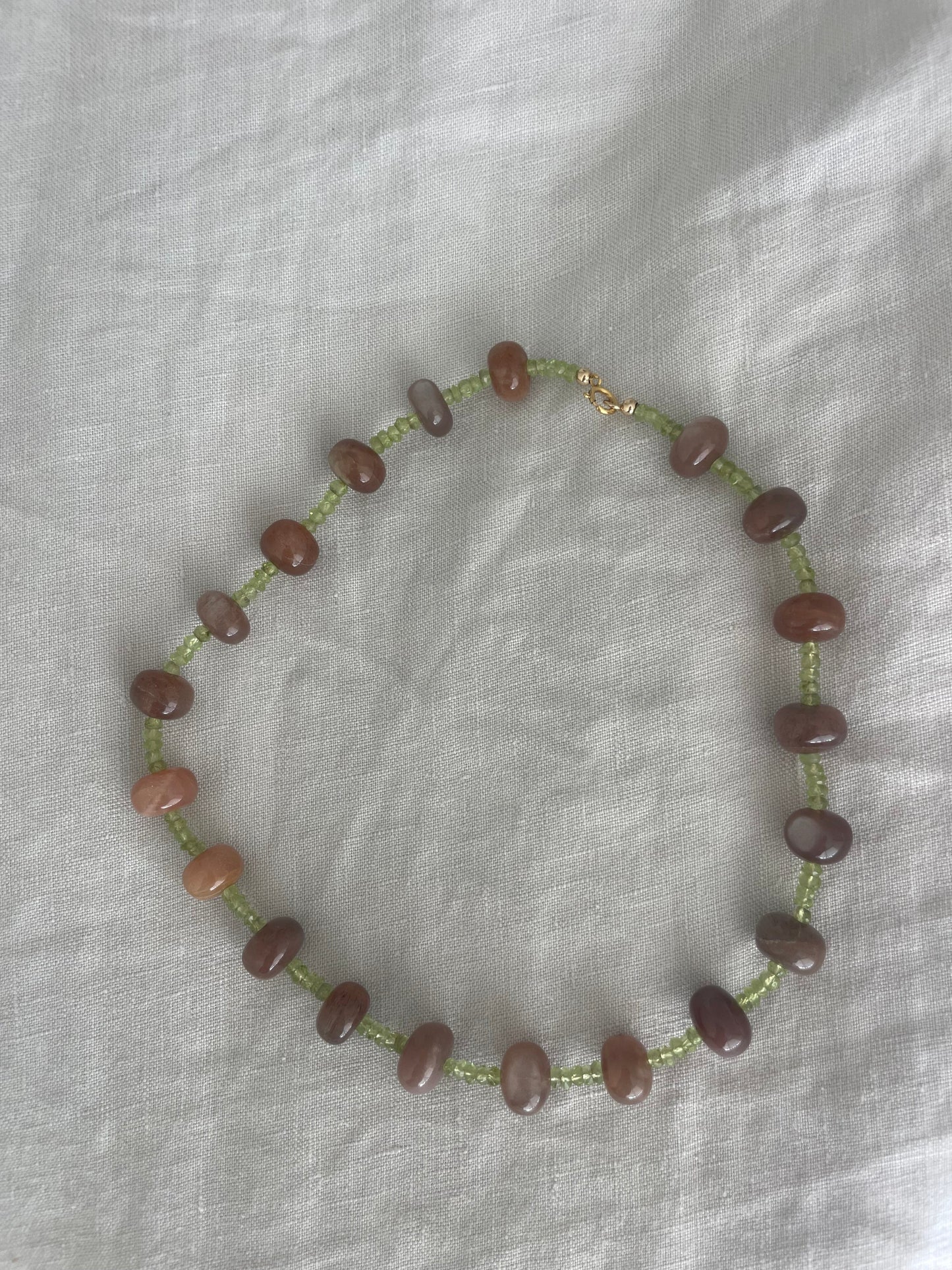 Beaded necklace on a light fabric background