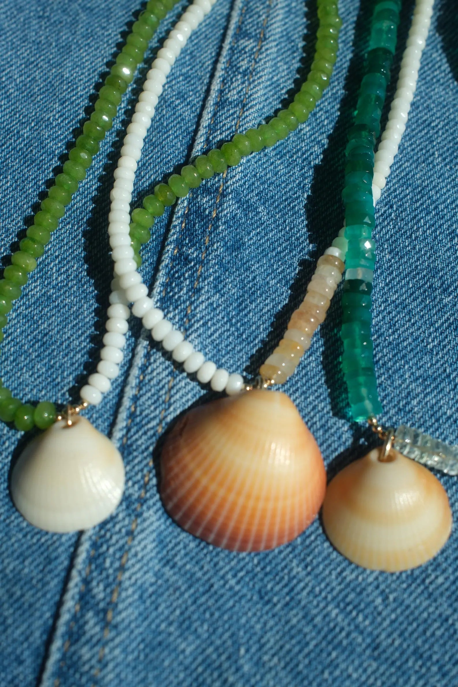 Necklace with shell pendants on a denim background